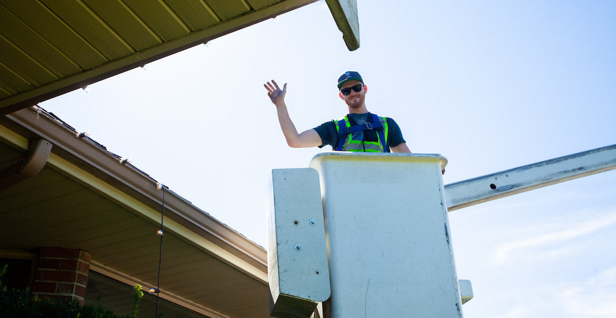 Smiling professional installer in bucket truck