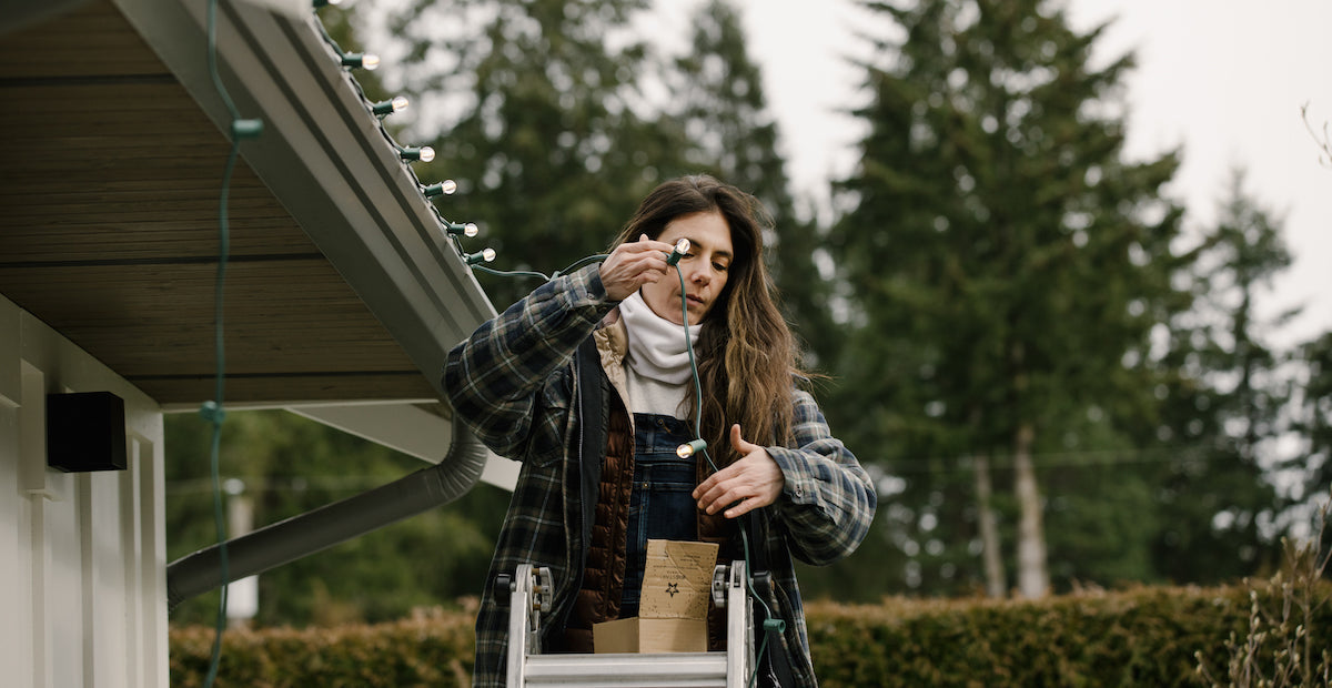 Woman stringing up warm white g30 bulbs