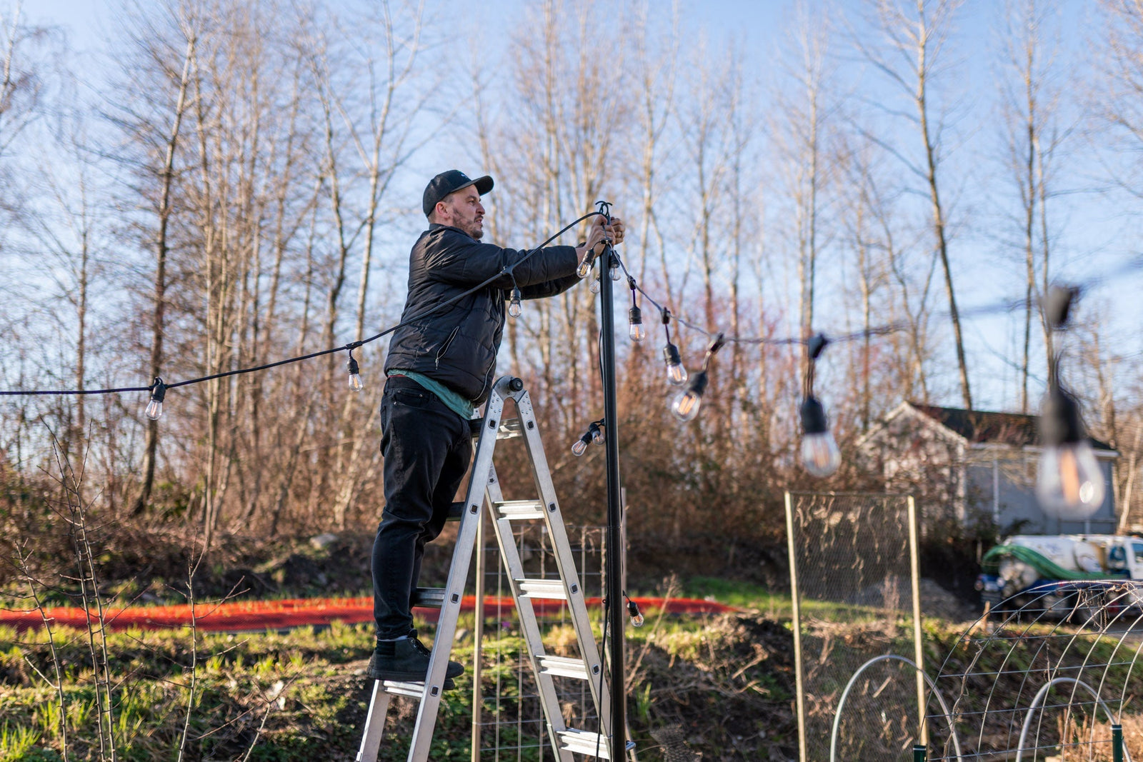 Professional Christmas Light Installer hanging Patio Lights